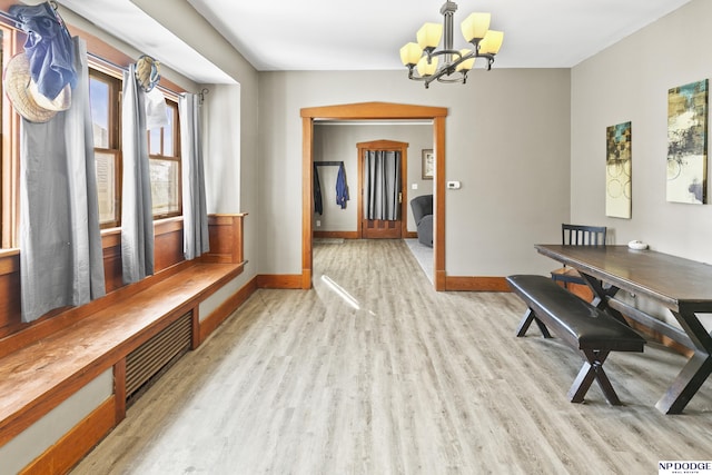 interior space featuring light hardwood / wood-style floors and a chandelier