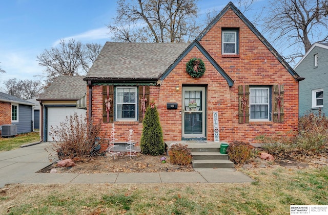 view of front of house with a garage and central AC unit