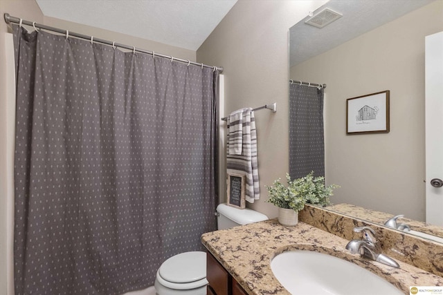 bathroom featuring toilet, sink, and a textured ceiling