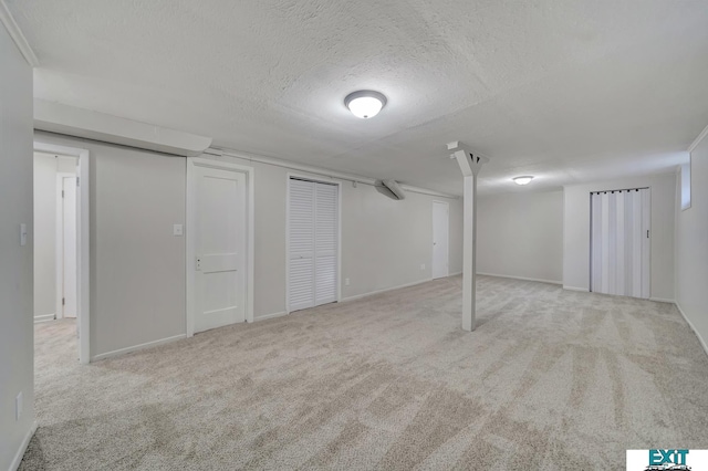 basement with light colored carpet and a textured ceiling