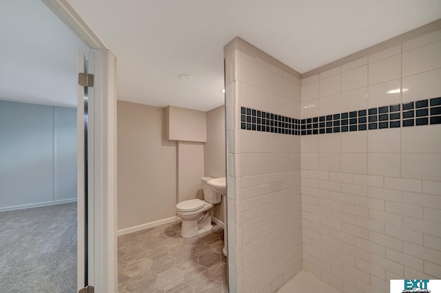 bathroom featuring toilet, tile patterned flooring, and walk in shower