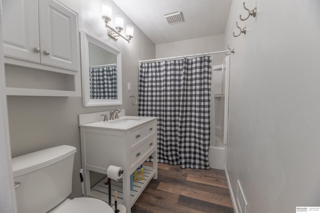 full bathroom featuring toilet, shower / tub combo, hardwood / wood-style floors, and vanity