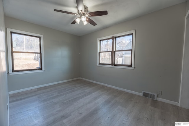 empty room featuring ceiling fan and light wood-type flooring