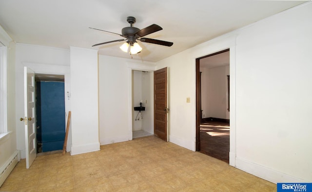 unfurnished bedroom featuring ceiling fan and a baseboard radiator