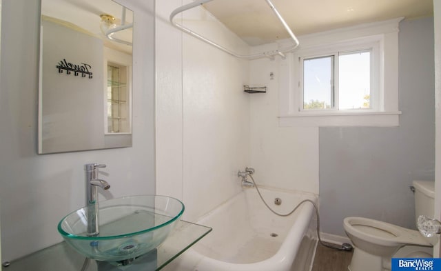 full bathroom featuring toilet, bathing tub / shower combination, and sink