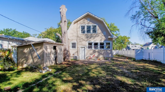 back of house with a lawn