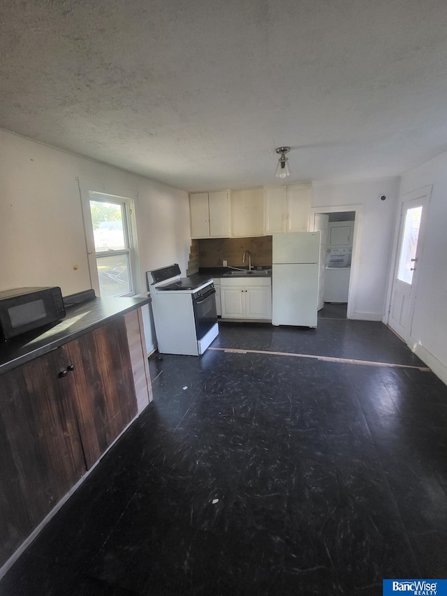 kitchen with white fridge, washer / dryer, decorative backsplash, electric stove, and sink