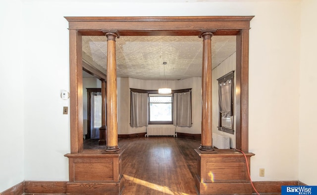 hallway with dark wood-type flooring and radiator