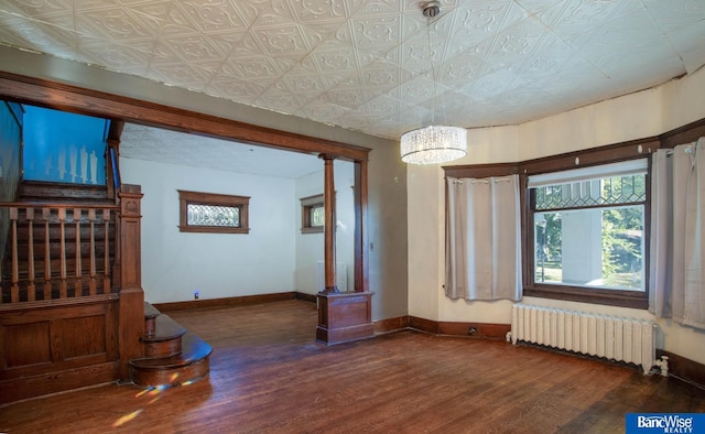 interior space with radiator, an inviting chandelier, and dark hardwood / wood-style flooring