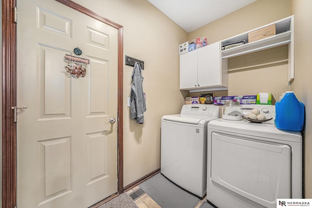 washroom with cabinets, washer and clothes dryer, and tile patterned flooring