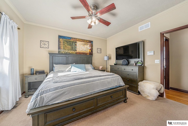 carpeted bedroom featuring ceiling fan and ornamental molding