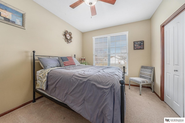 carpeted bedroom with ceiling fan and a closet