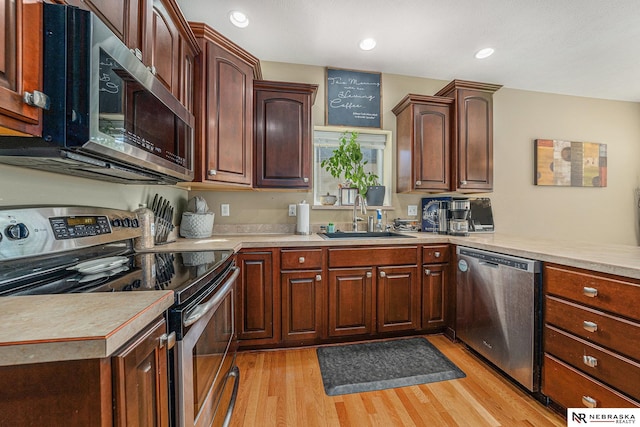 kitchen featuring sink, light hardwood / wood-style flooring, and stainless steel appliances