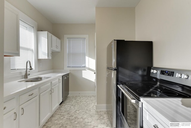 kitchen with sink, white cabinets, and stainless steel appliances