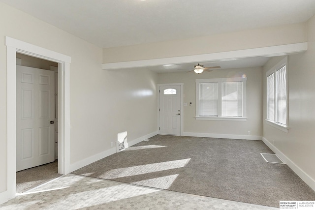 carpeted entryway featuring ceiling fan