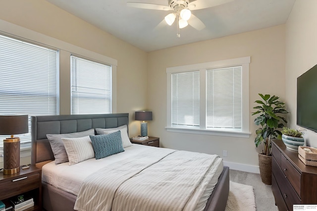 bedroom with ceiling fan and light carpet