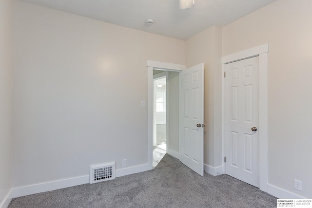 unfurnished bedroom featuring carpet floors and a closet