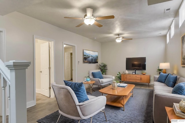 living room with hardwood / wood-style flooring and ceiling fan