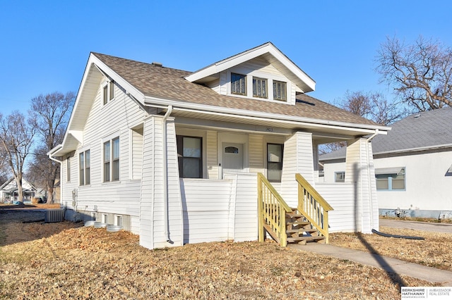 view of front of home with a porch and central air condition unit