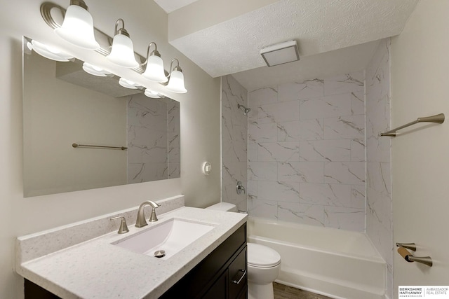 full bathroom with toilet, hardwood / wood-style flooring, tiled shower / bath, a textured ceiling, and vanity