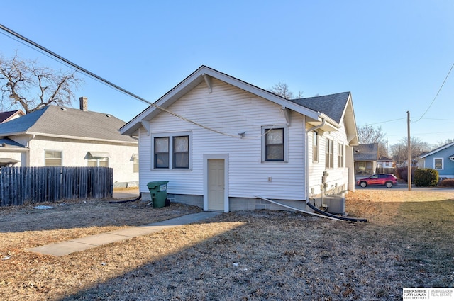 rear view of property featuring central AC