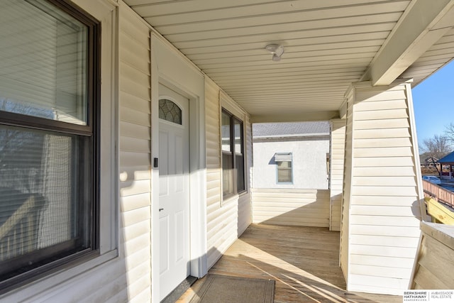 wooden terrace featuring covered porch