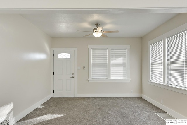 entrance foyer featuring ceiling fan and carpet floors