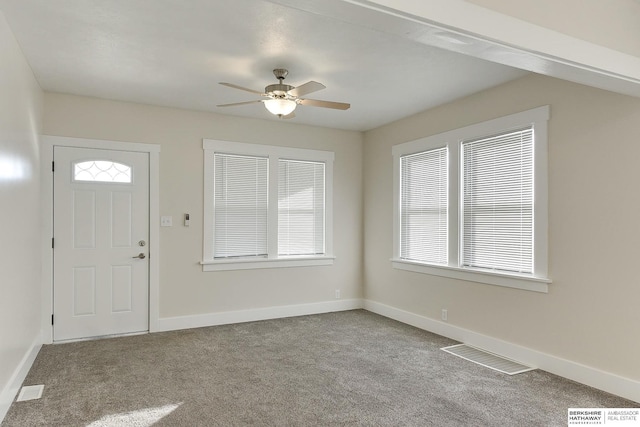 carpeted foyer featuring ceiling fan