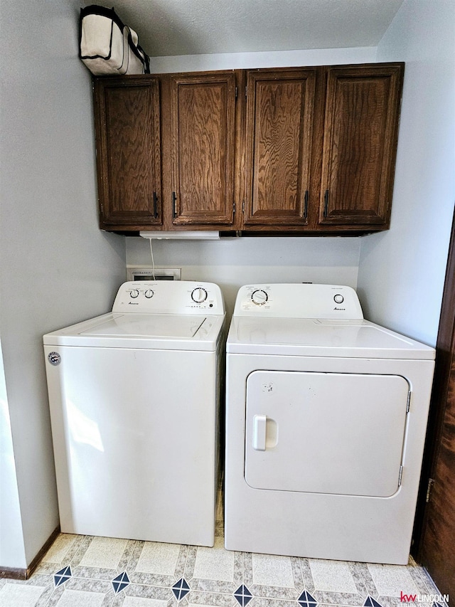 laundry area featuring cabinets and separate washer and dryer