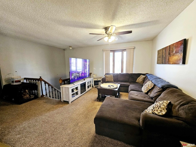 living room featuring a textured ceiling, carpet floors, and ceiling fan