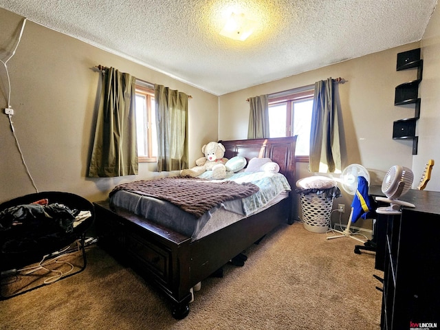 bedroom featuring carpet floors and a textured ceiling