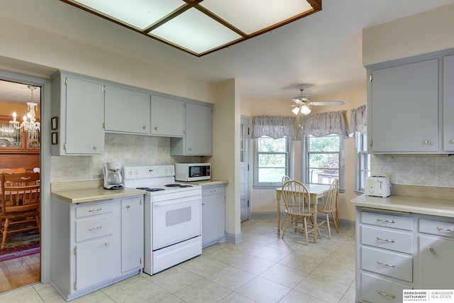 kitchen featuring ceiling fan, white appliances, decorative backsplash, and gray cabinetry