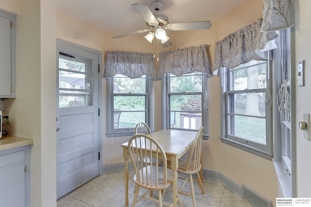 dining space featuring ceiling fan and light tile patterned floors