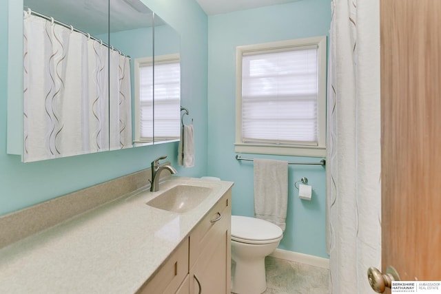 bathroom with toilet, tile patterned flooring, and vanity