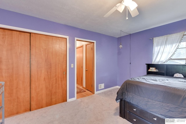 bedroom featuring ceiling fan and light colored carpet