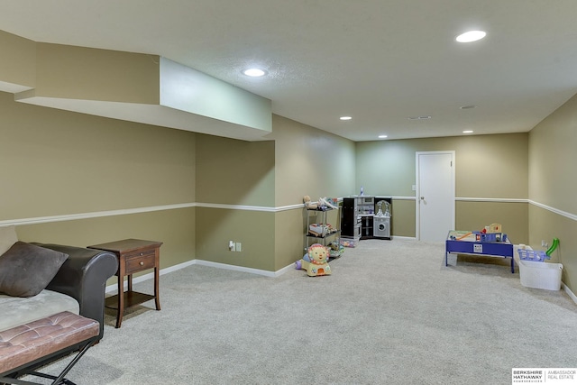 rec room with light colored carpet