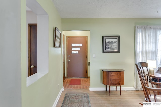 entrance foyer featuring a textured ceiling and light hardwood / wood-style floors