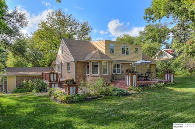 back of house featuring a wooden deck and a yard