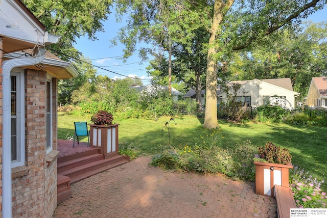 view of yard featuring a patio area and a wooden deck