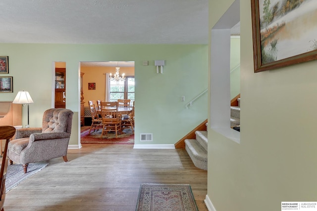 interior space featuring an inviting chandelier and light hardwood / wood-style floors