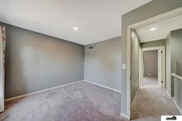 unfurnished room with light colored carpet