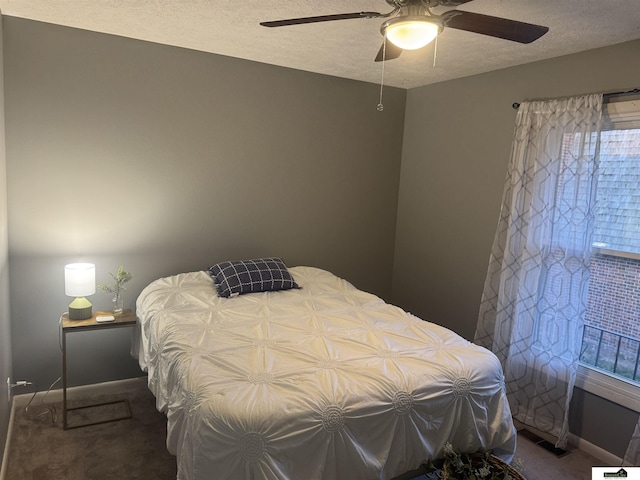 carpeted bedroom with a textured ceiling and ceiling fan