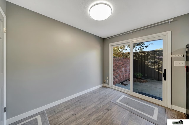 unfurnished room with light hardwood / wood-style floors