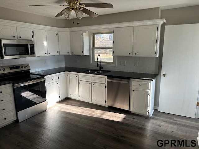 kitchen featuring stainless steel appliances, backsplash, white cabinets, and sink