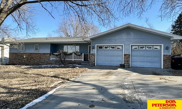 ranch-style home featuring a garage and a porch