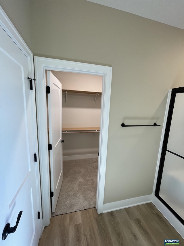 interior space featuring baseboards and wood finished floors