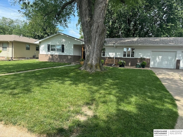 ranch-style house with a garage and a front yard