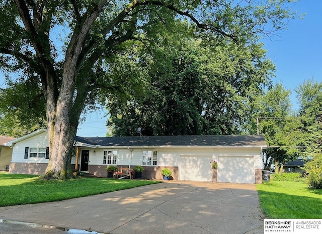 ranch-style home with a garage and a front lawn