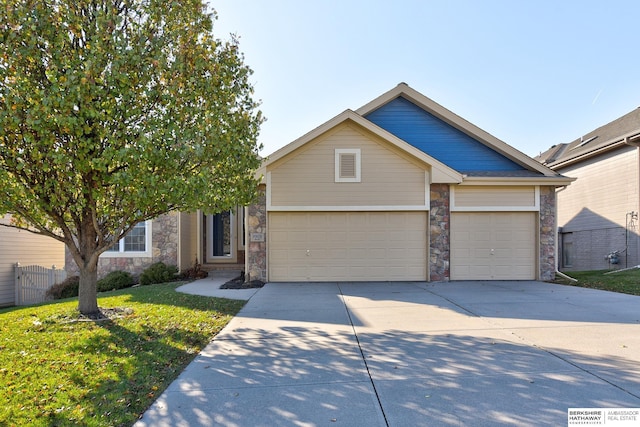 view of front of home with a garage and a front lawn