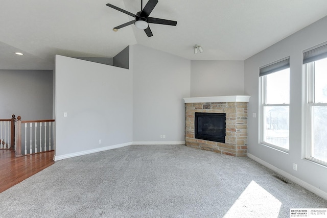 unfurnished living room featuring ceiling fan, carpet flooring, and a fireplace